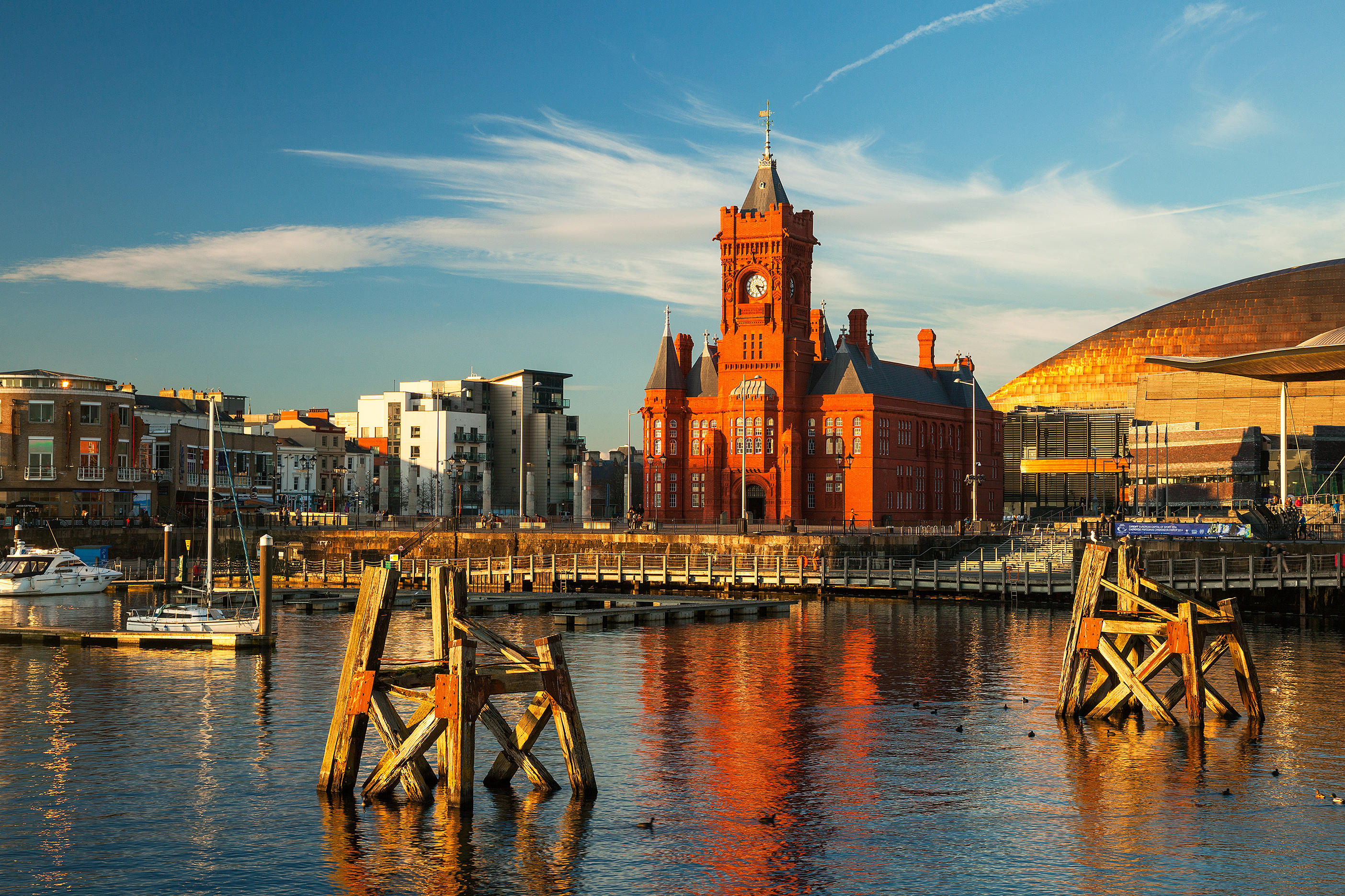 Historic building, residential and commercial properties in Cardiff Bay beside the harbour at sunset