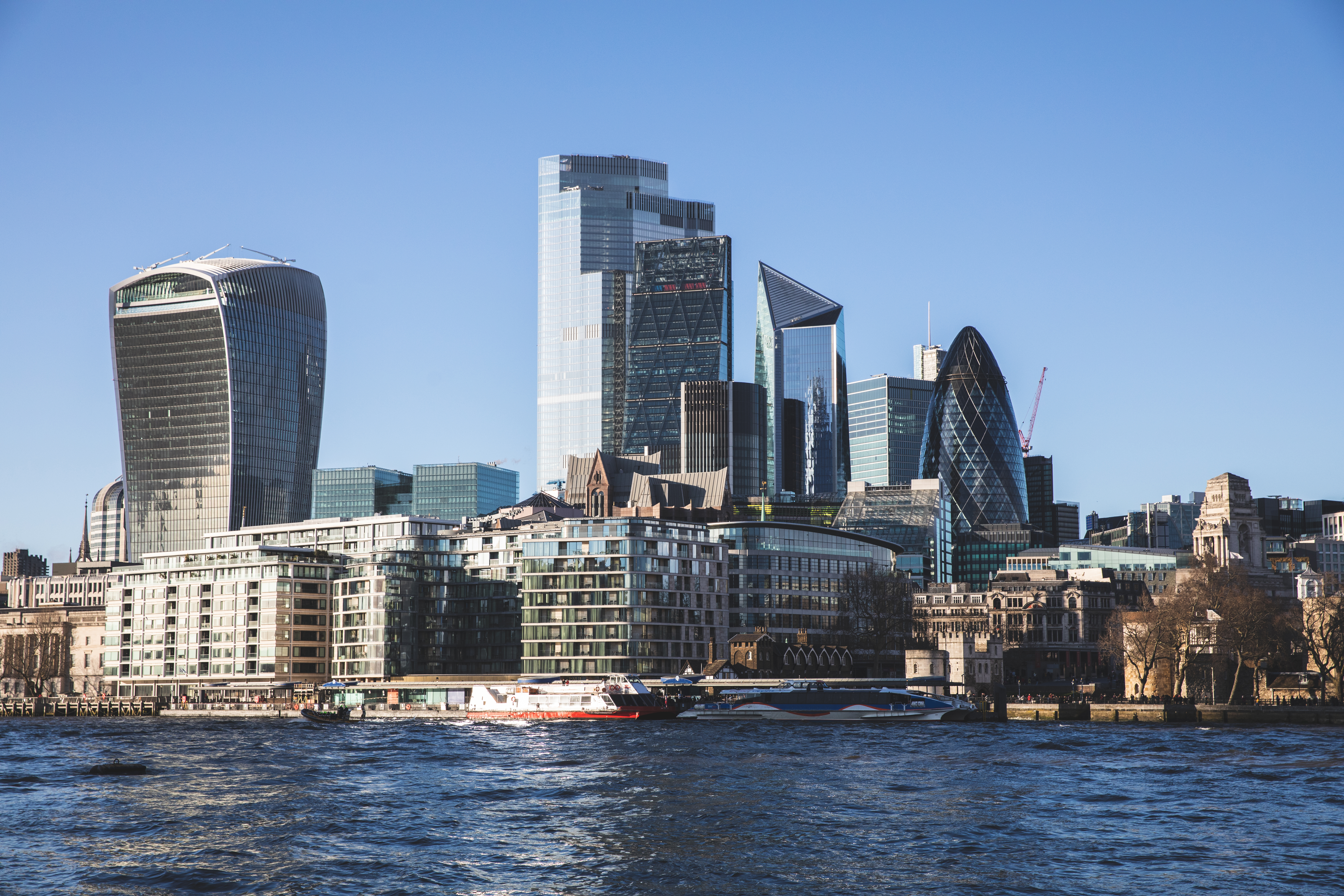 views over the Thames River with iconic skyscrapes in the City of London in the background