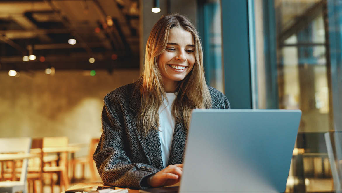 An image of a young woman looking at her laptop