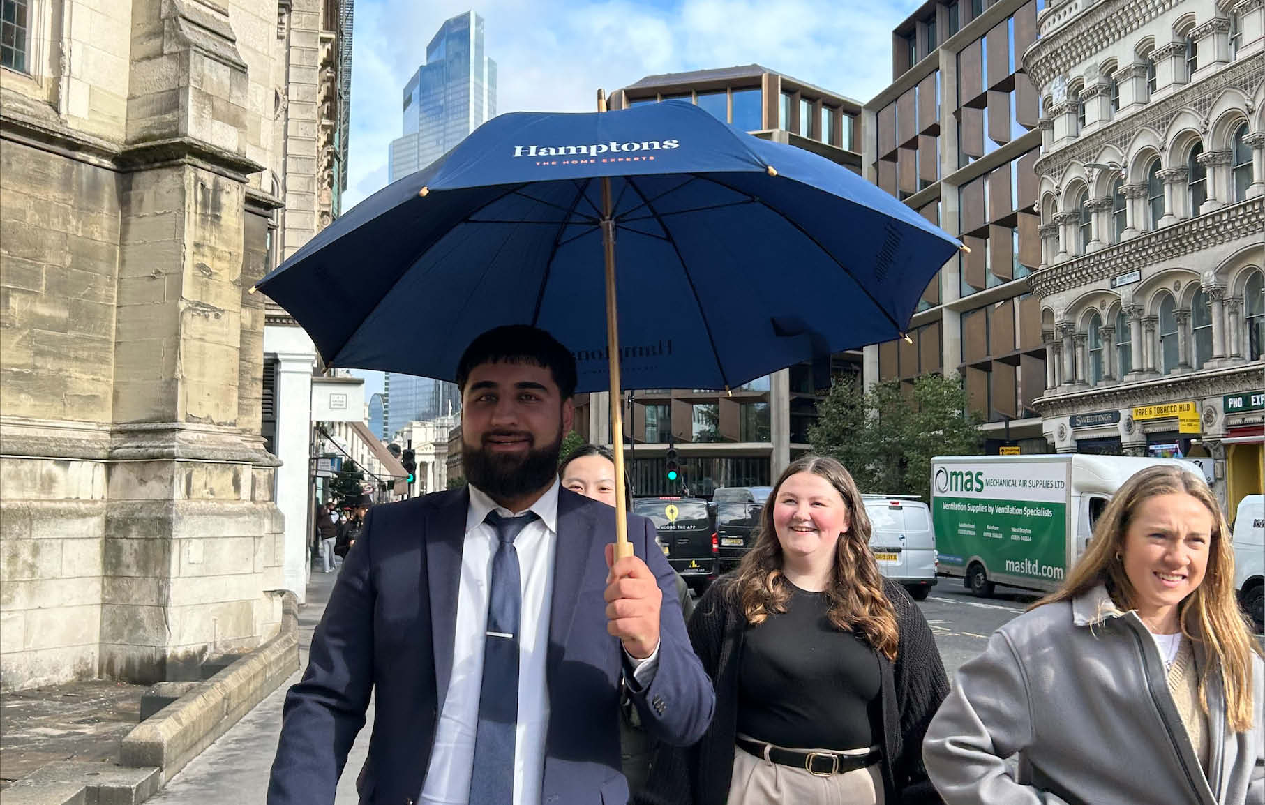 A group of Avison Young staff walking through the city