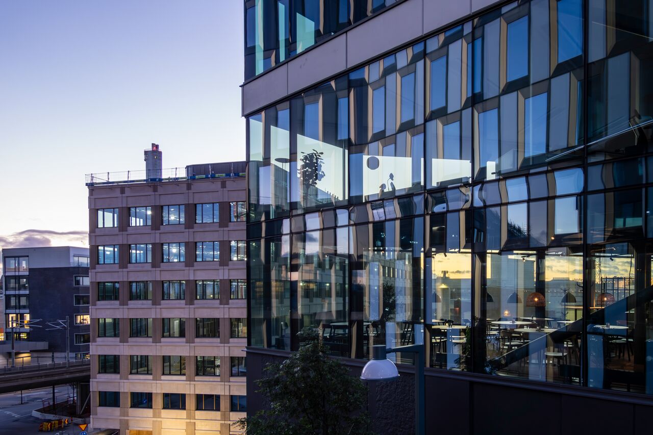 Urban scene with modern glass building reflecting cityscape