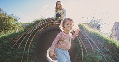 An image of young children playing in a field