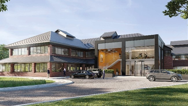 Modern office building on Surrey Science Park in England, with large glass entrance, brick facade, and landscaped surroundings. Cars parked in front; people walking. Bright, inviting atmosphere.