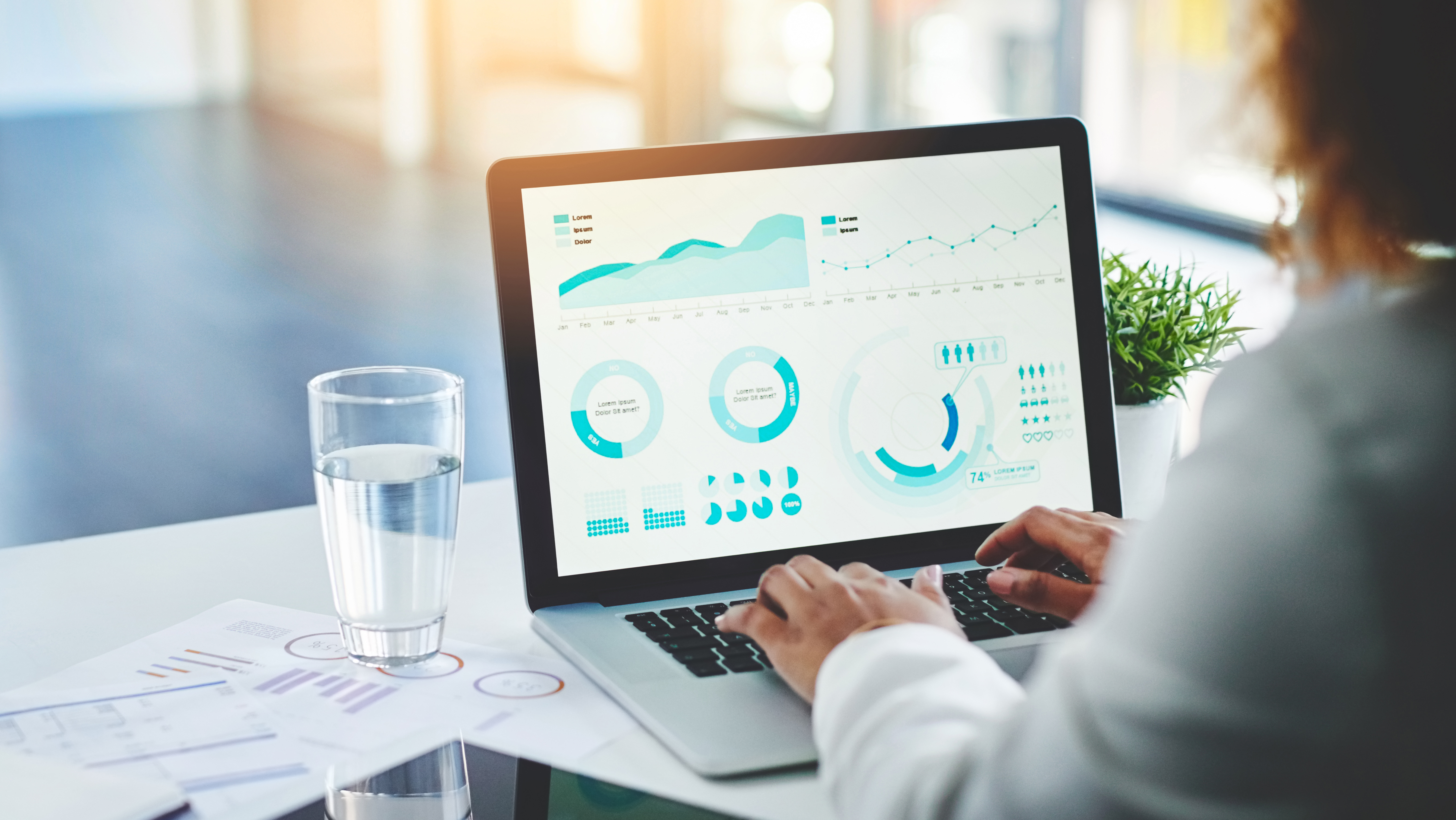 metrics on a dashboard with insight professional sat at a computer evaluating performance