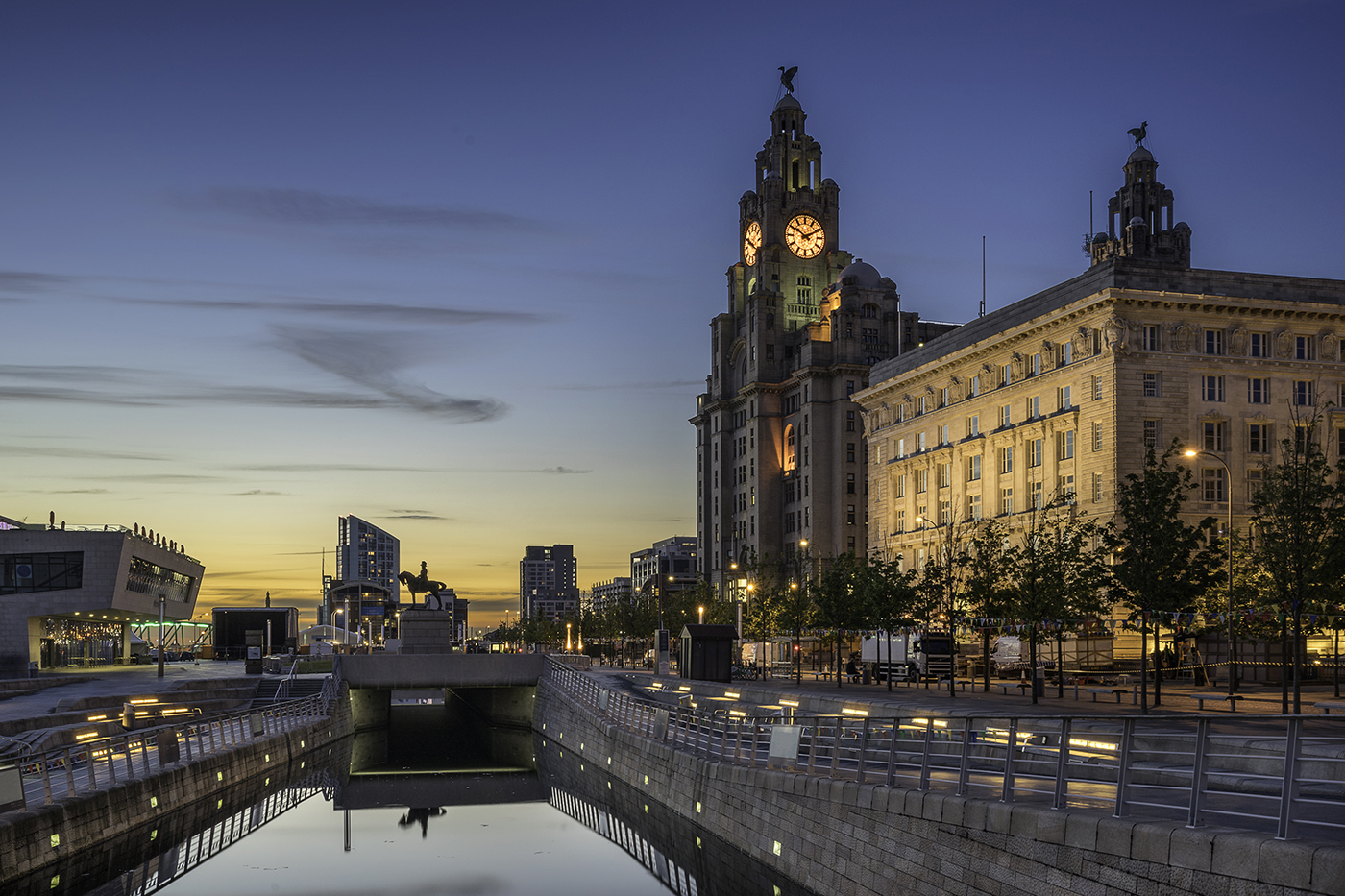 The Three Graces a view of historic Liverpool along with a regenerated waterside location in the evening with commercial property in the background
