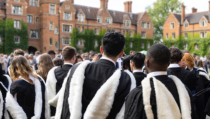 Students standing outside of a British University in robes