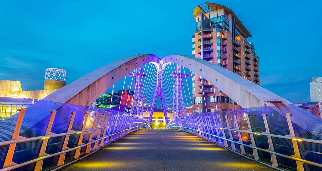 View of an illuminated footbridge in Salford quays during night in Manchester, England