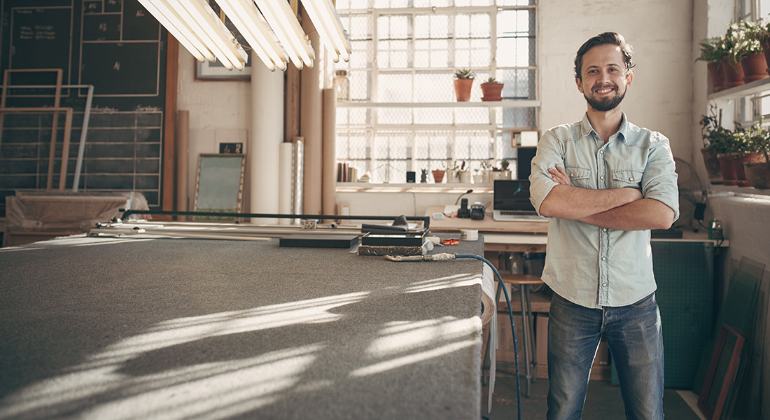 Worker standing by the end of the desk