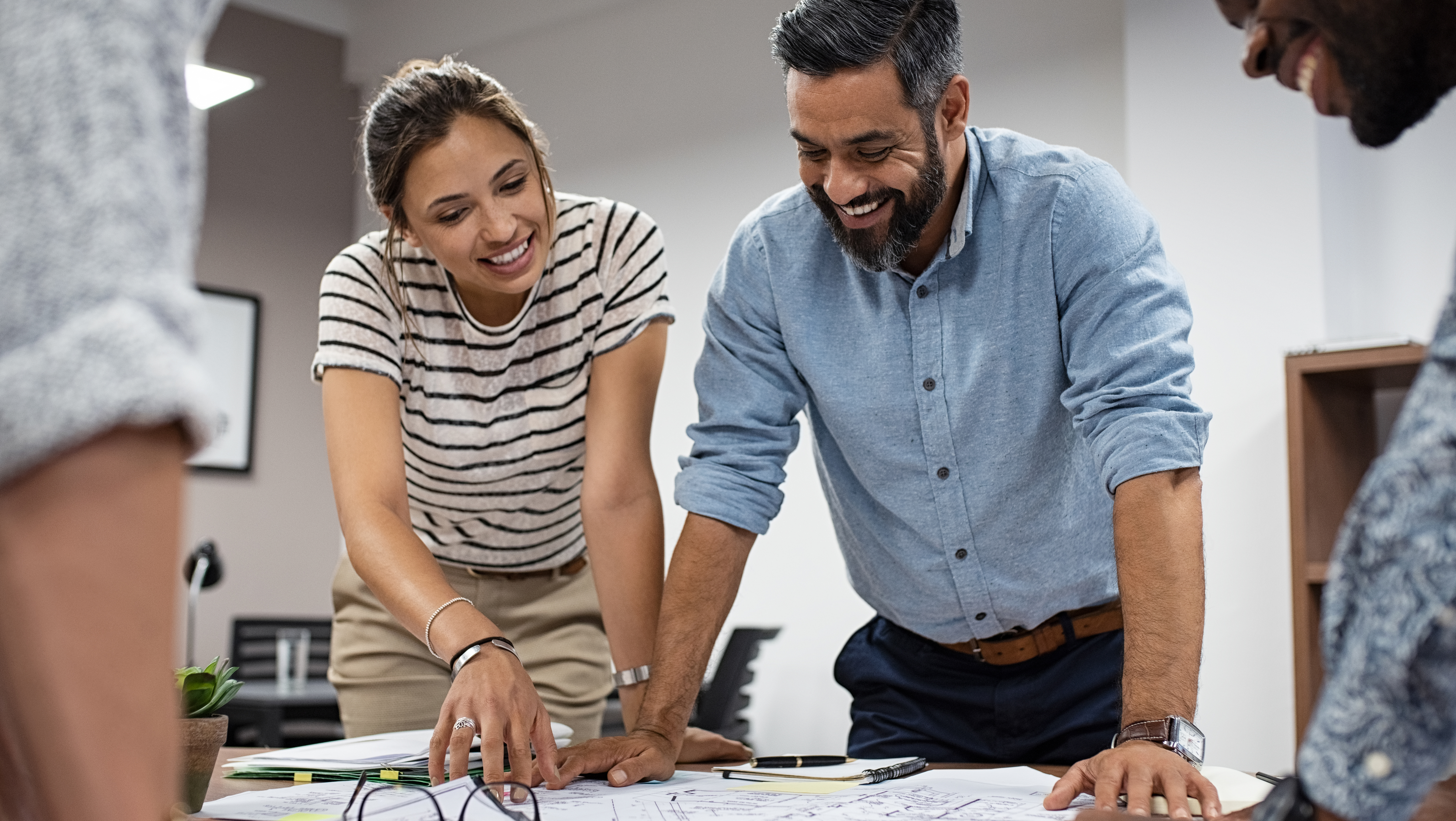 Male and female architect reviewing plans for new public sector building