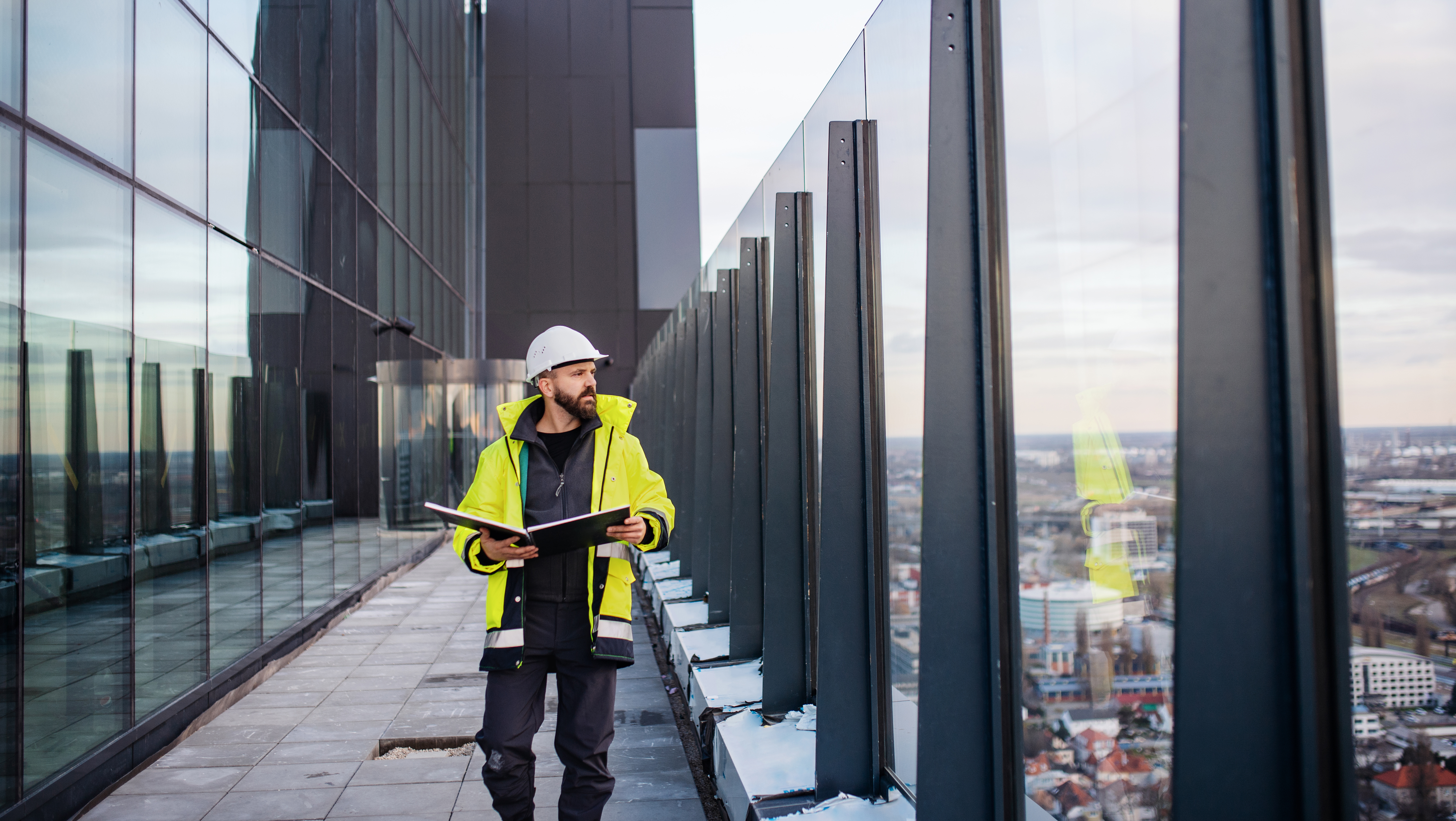 templafy-two-construction-workers-discussing-plans-in-a-large-empty-warehouse-1